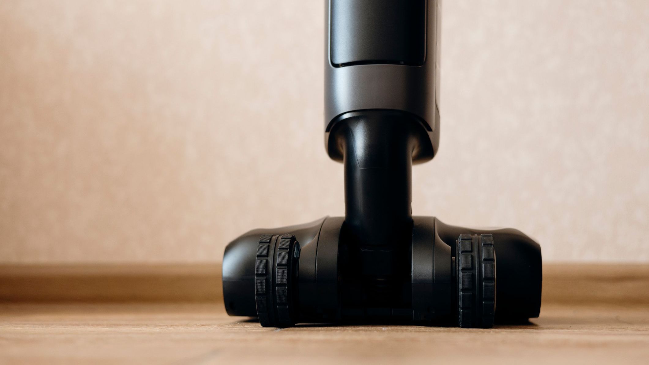 Cordless wet and dry vacuum cleaner standing on wooden floor