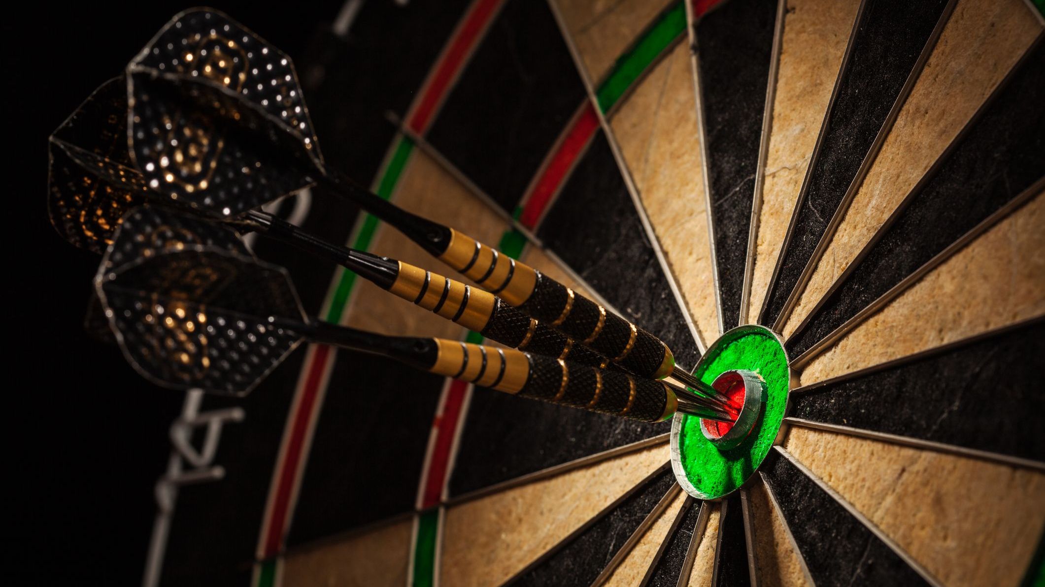 Three darts in bull's eye close up