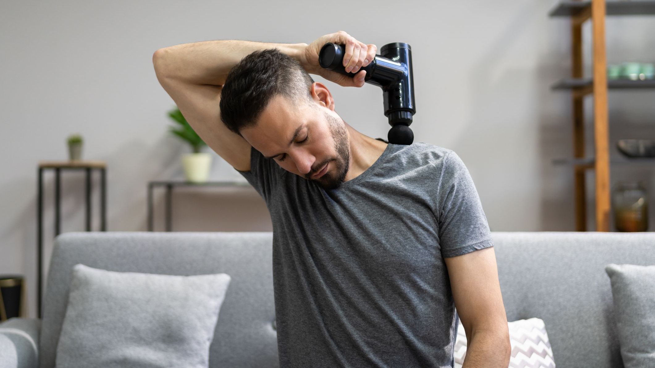 Man with Massage Gun Machine Recovery Therapy