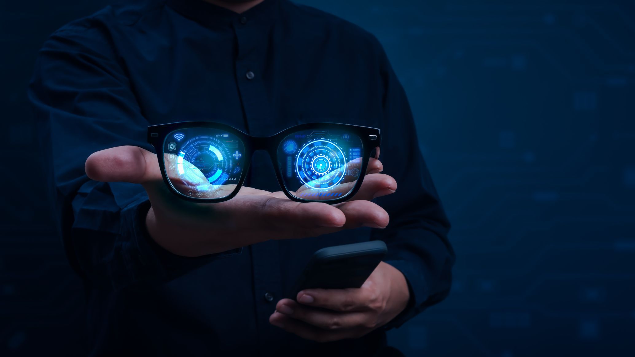 Person holding AI smart glasses with futuristic augmented reality interface and digital hologram display. Concept of wearable technology, ar