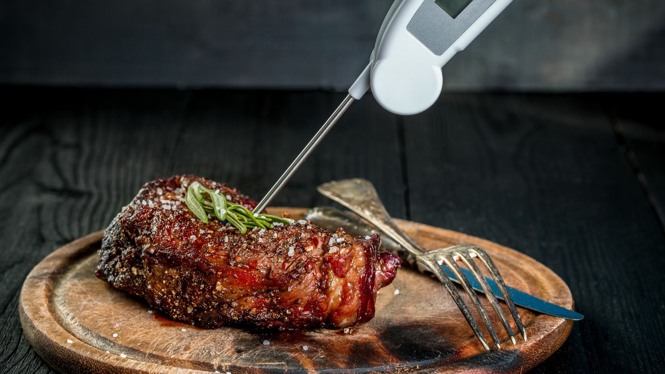 Grill juicy beef T-bone steak with salt pepper and rosemary