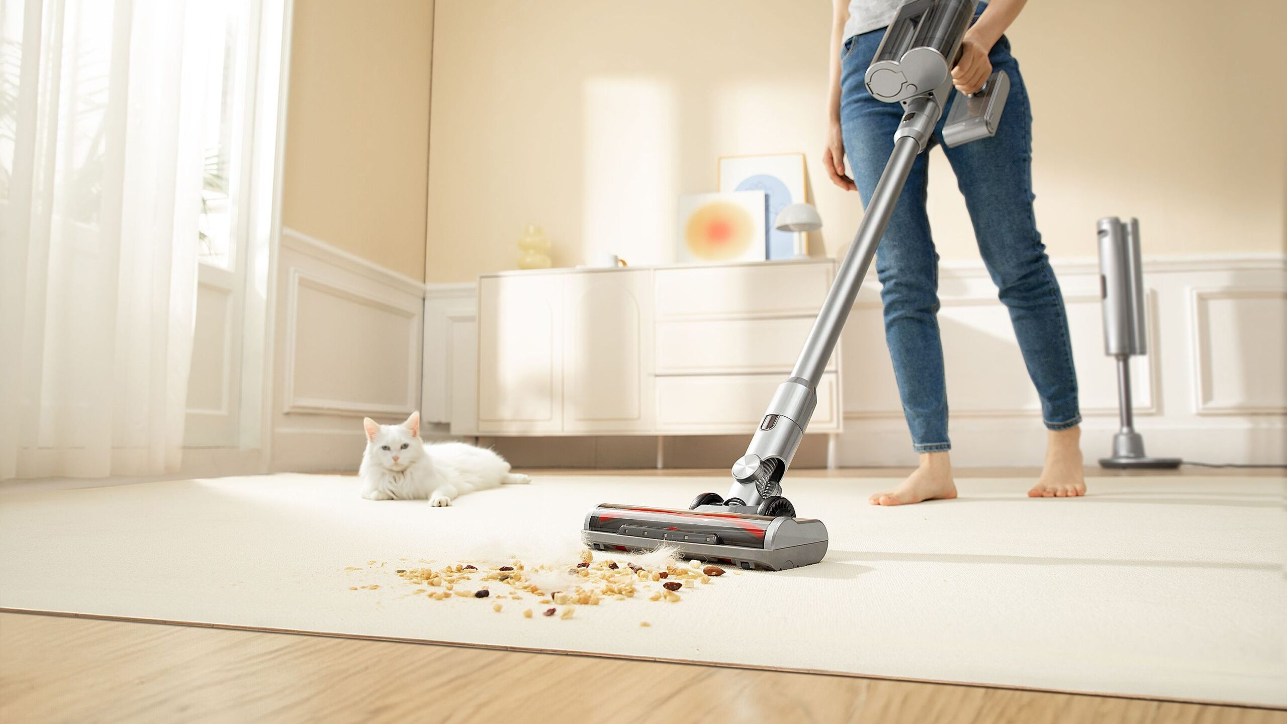 A woman is using a vacuum cleaner to clean a pet's room, dirty carpet and pet hair