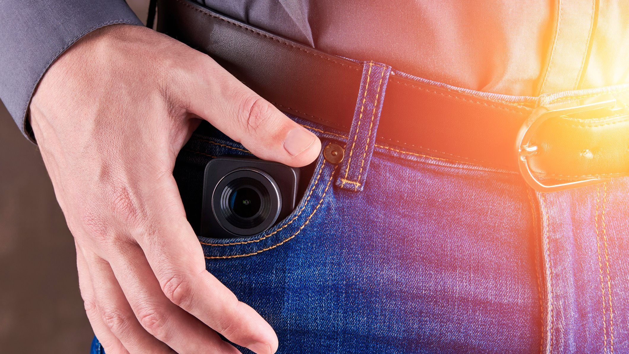 Hidden photo or video camera at jeans pocket. harassment and blog concept