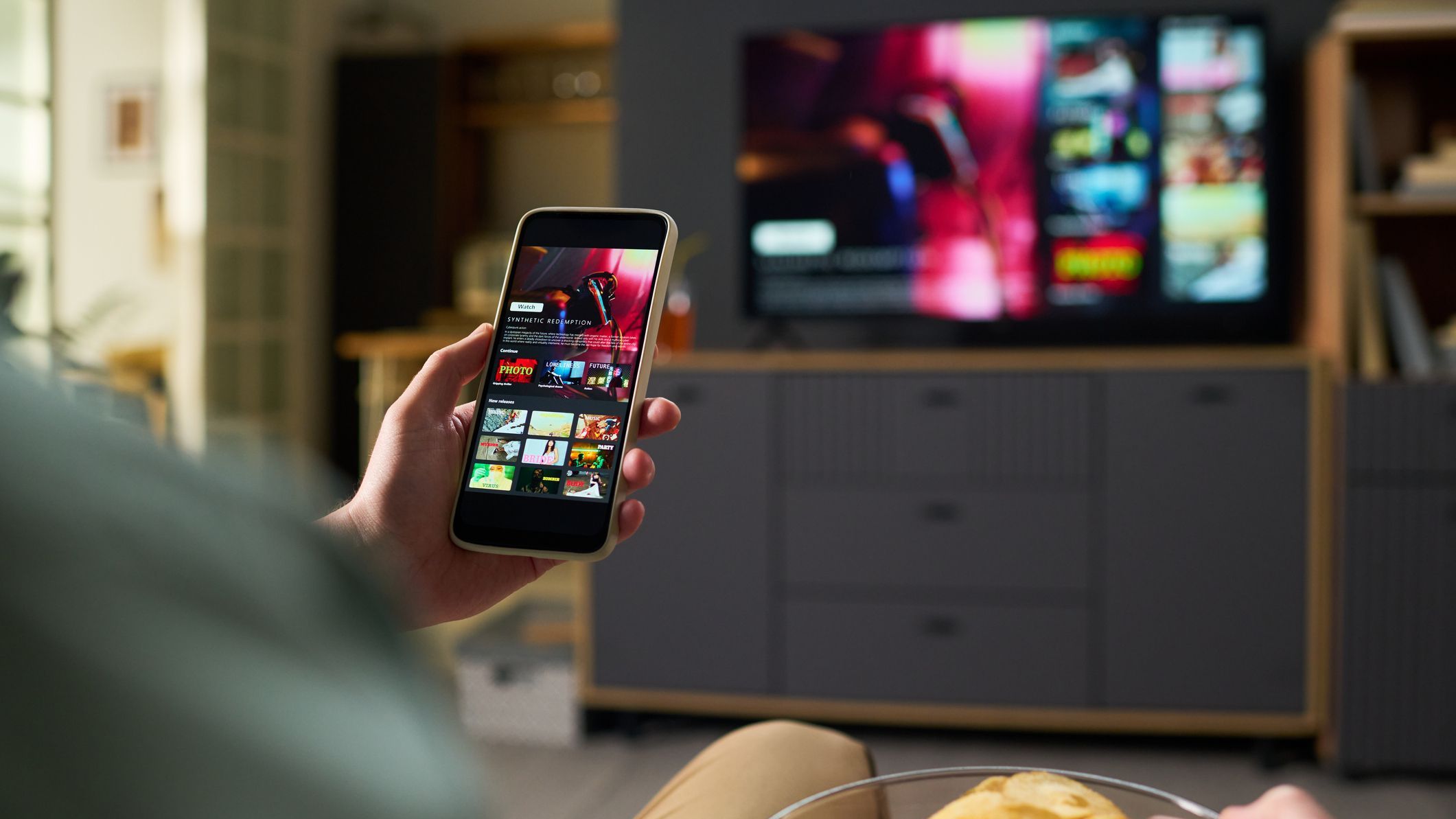 Unknown Man Watching Streaming Service on Smartphone at Home