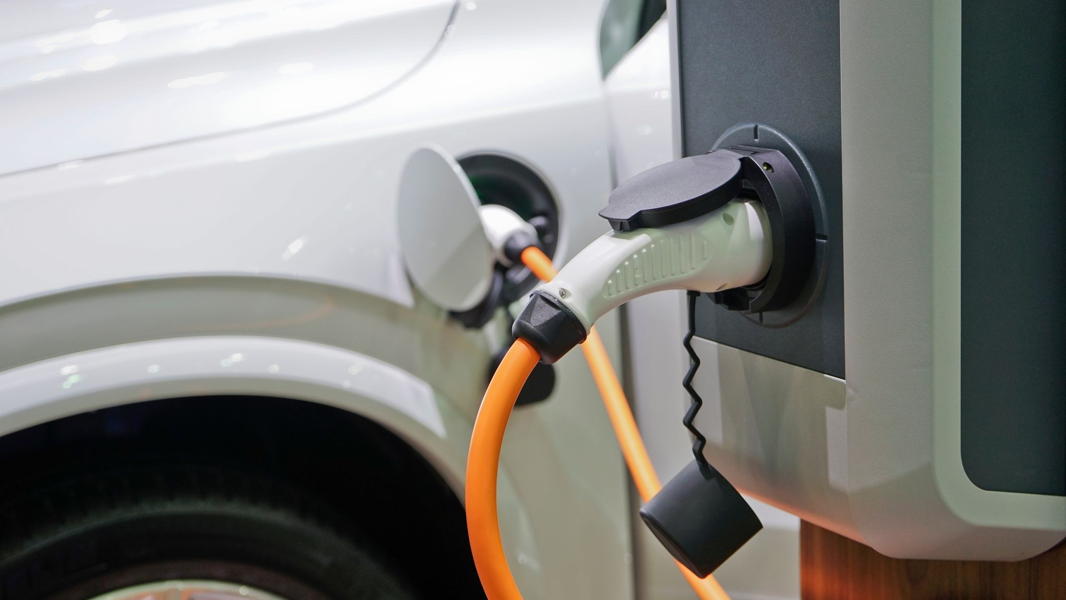 Electric car charging on parking lot.