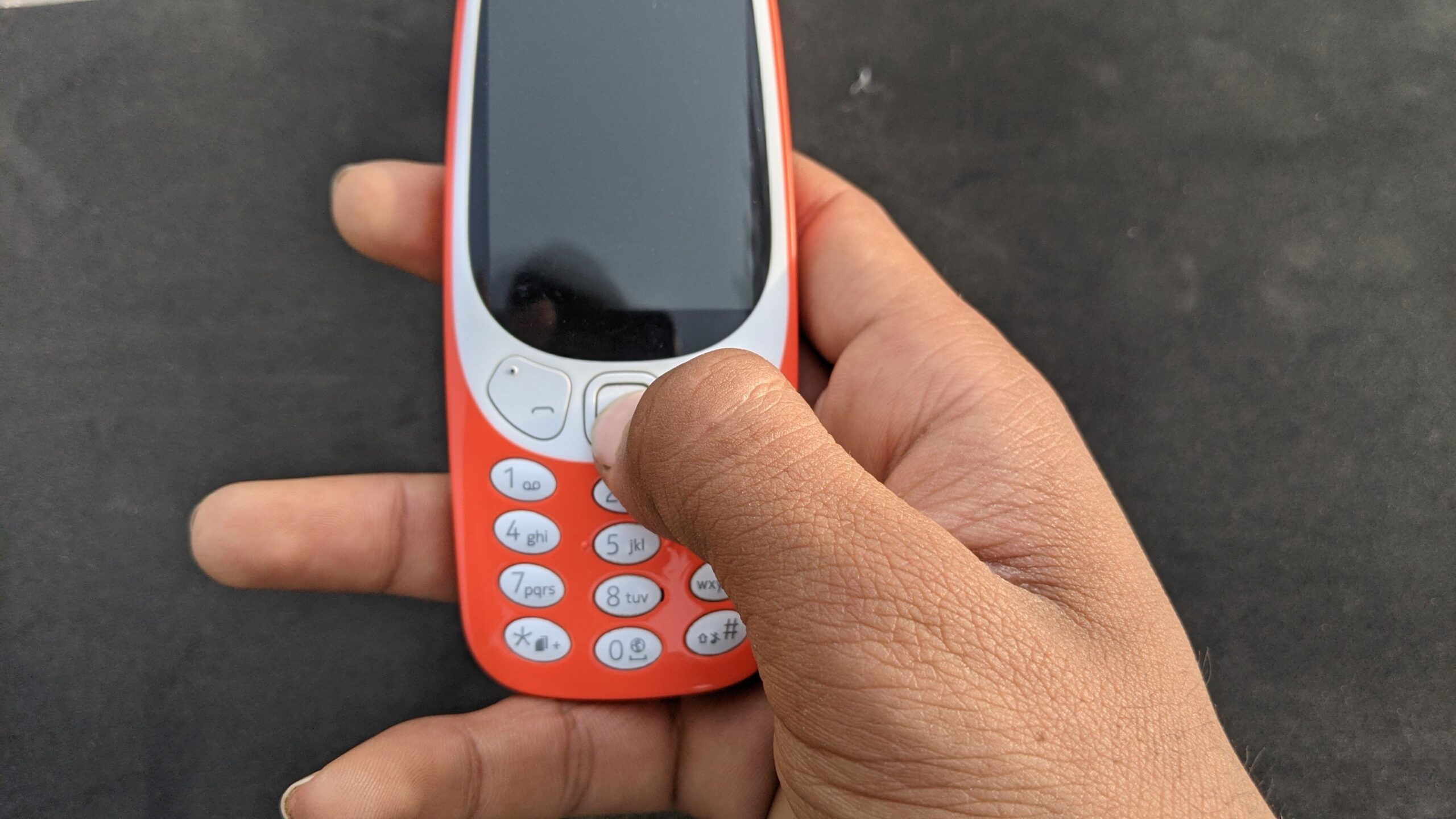 Cell phone buttons and black display and keys dialing in hands